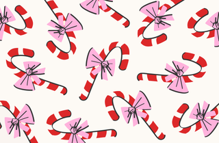 Pattern of red and white candy canes with pink bows on a white background