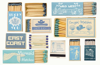 Collection of matchboxes with various designs and text on a white background